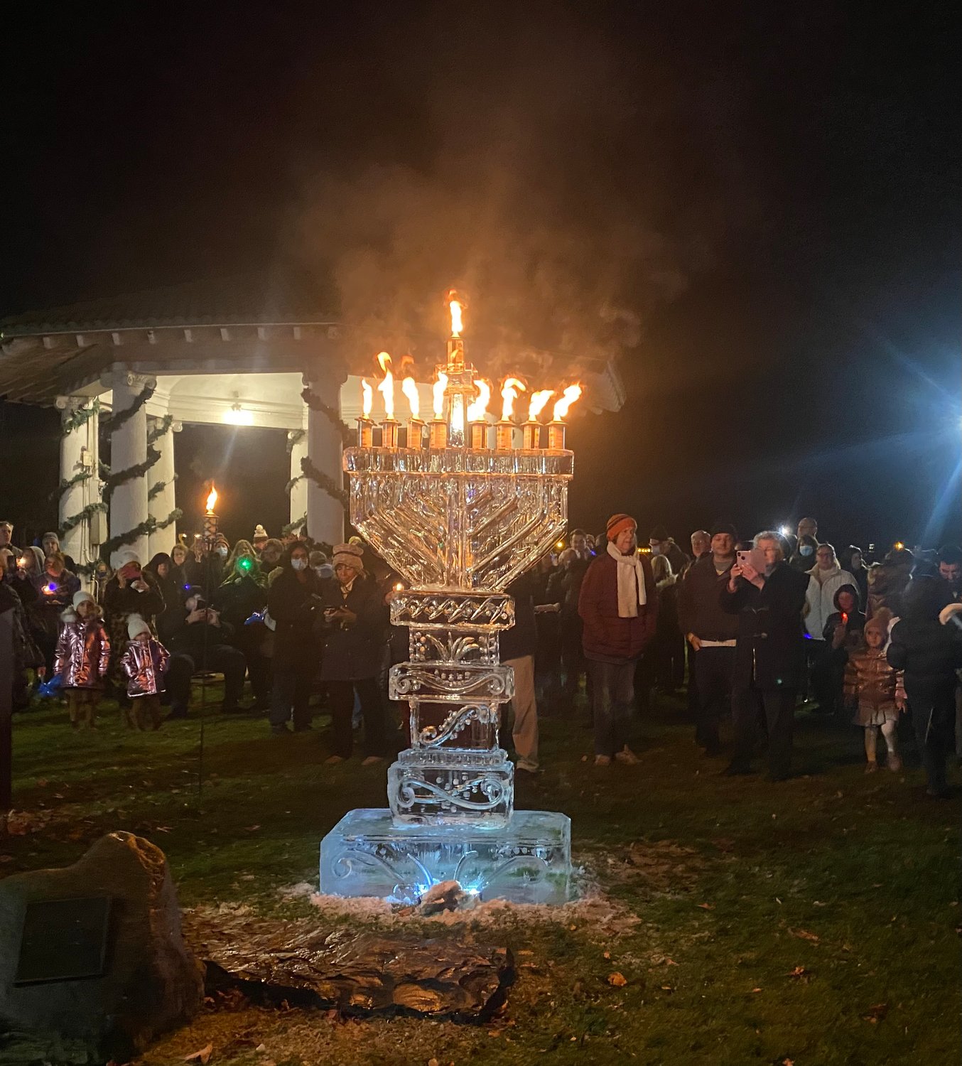 The ice carver works to create the 7-foot-tall menorah sculpture.